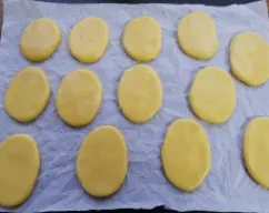 Step <p>Sacar la masa del vaso y dar forma a las tortas, colocarlas en la bandeja con papel de horno, hornearlas durante unos 15 minutos a 180º, hasta que se dore un poco la parte de abajo, de esta masa saldrán como para dos tandas, unas 25 tortas.</p> illustration